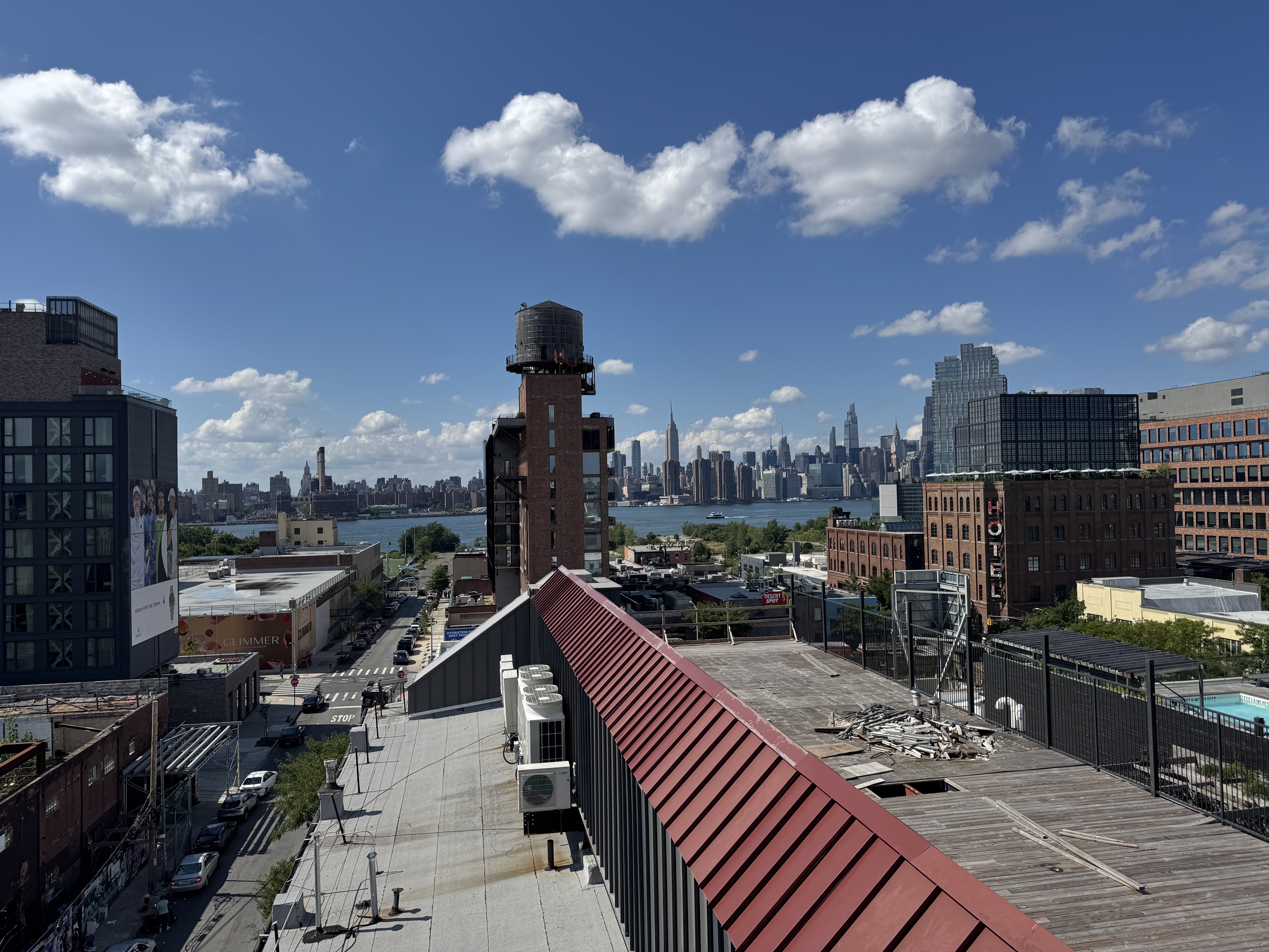 View from the building roof over Williamsburg rooftops and the East River to the full Manhattan skyline