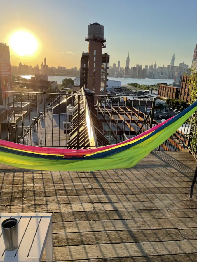 Hammock on the terrace at sunset with the Manhattan skyline and East River in the distance